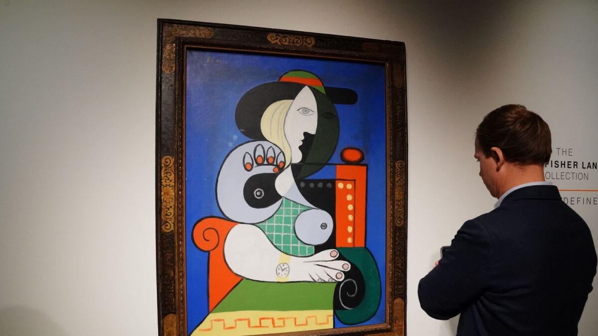 A visitor looks over Pablo Picasso’s painting Femme á la montre at Sotheby’s in New York. — AFP