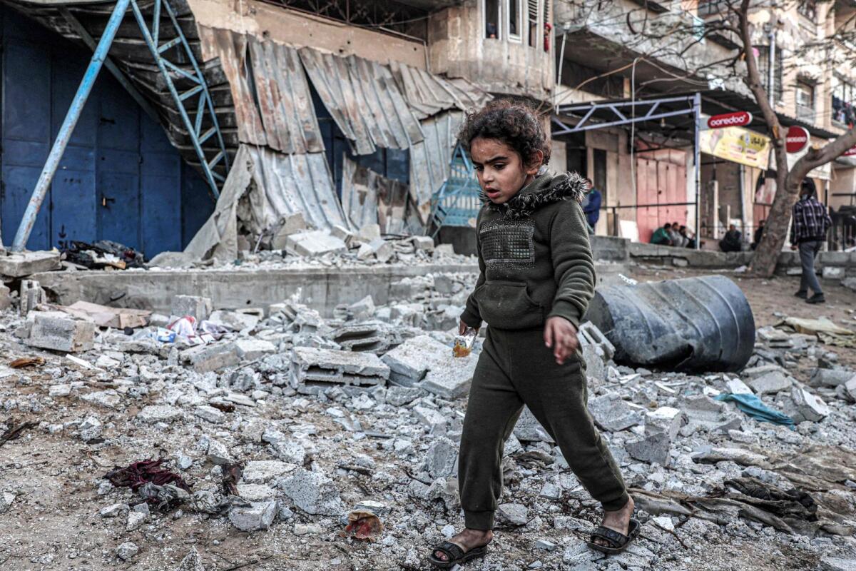 A Palestinian girl walks through rubble in an area that was hit by reported Israeli bombardment in Rafah in the southern Gaza Strip on February 7. — AFP