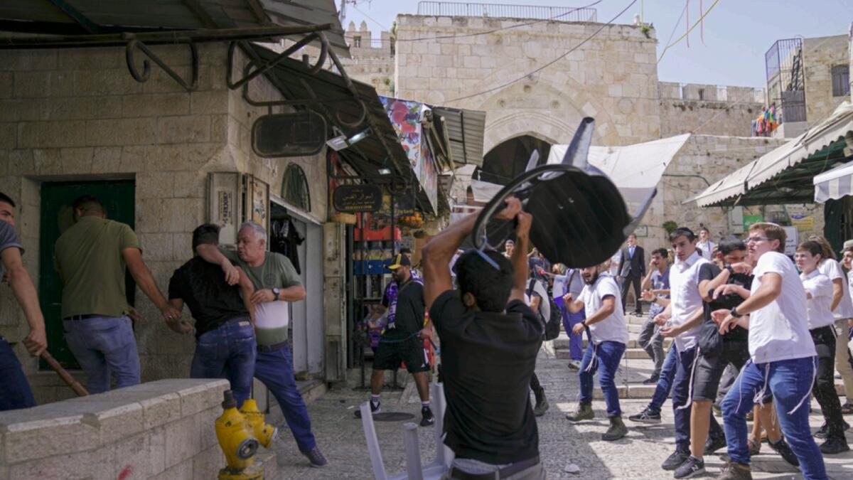 Palestinians and Jewish youths clash in Jerusalem's Old City as Israelis mark Jerusalem Day. — AP