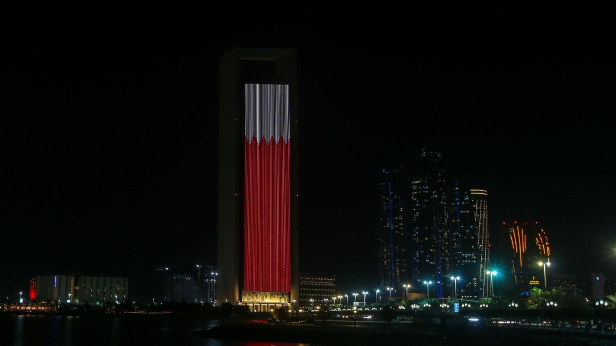 Abu Dhabi’s Adnoc building lit up in the colours of the  Bahrain flag on Wednesday, December 16.
