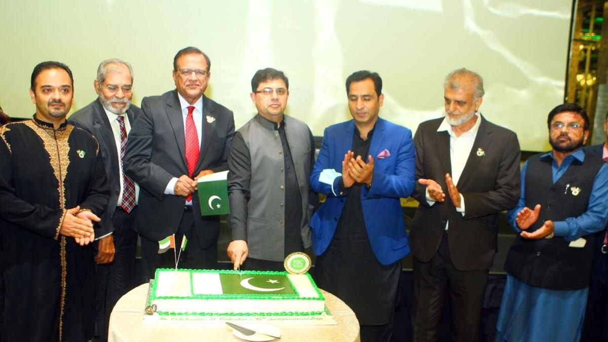Hassan Afzal Khan, Iqbal Dawood, Shabbir Merchant and other guests at the cake-cutting ceremony to mark Pakistan's 75th Independence Day in Dubai late on Wednesday. -- Photo by Mohammed Mustafa Khan