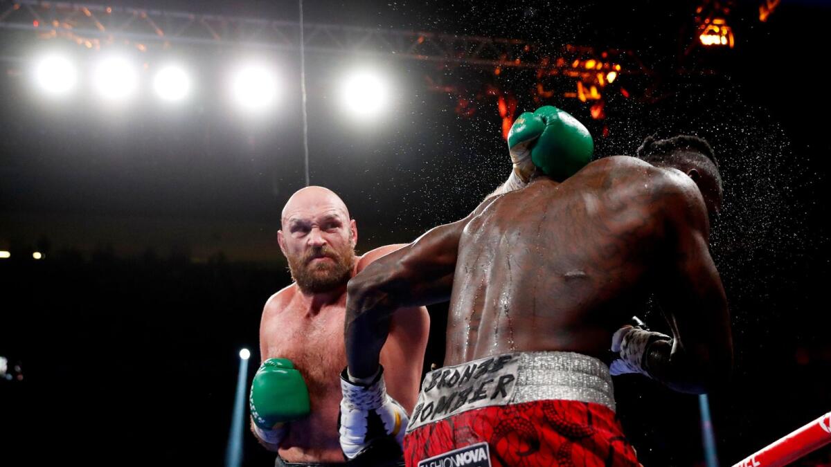 Tyson Fury punches Deontay Wilder during their heavyweight clash on Saturday. (Reuters)