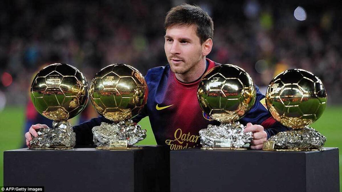 Messi poses with his four Ballon d'Or trophies before a La Liga match in January 2013 after picking up the award for 2012.