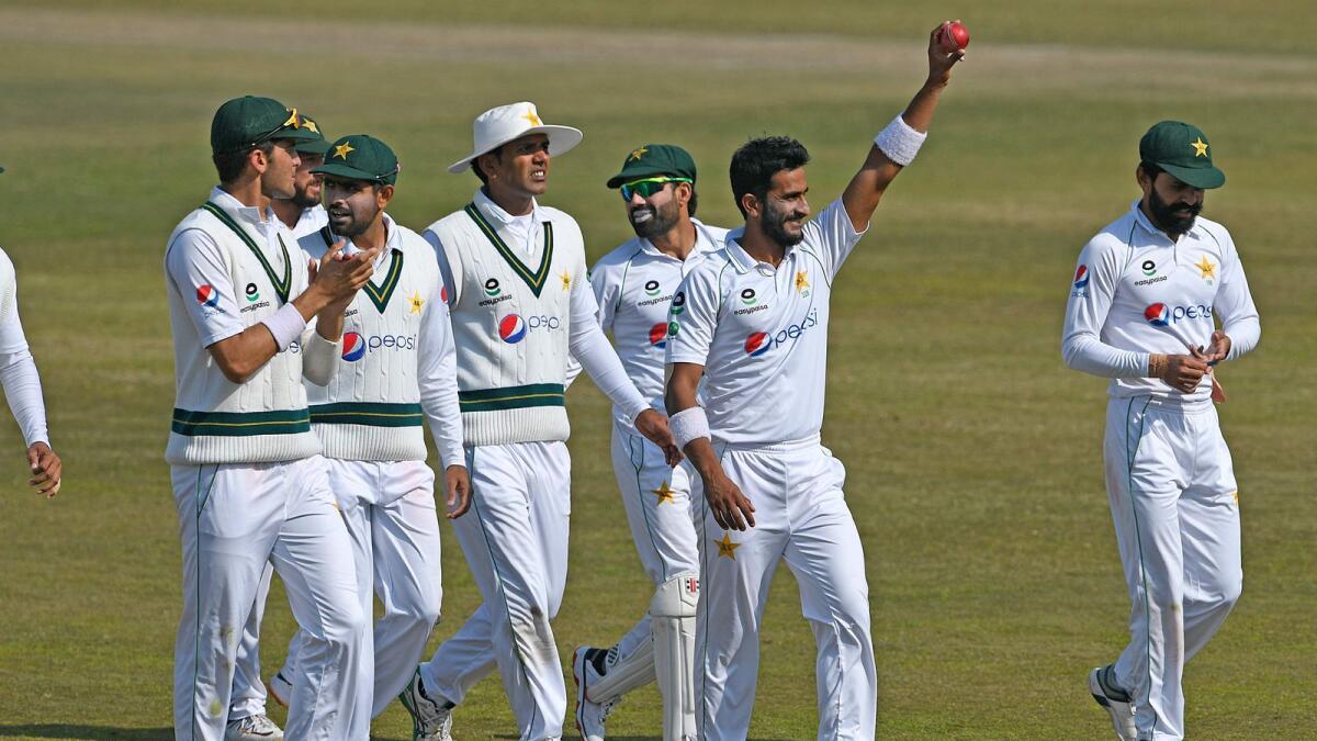 Pakistan's Hasan Ali holds the ball as his teammates congratulate him after he took five wickets at the end of the South Africa's first innings. — AFP