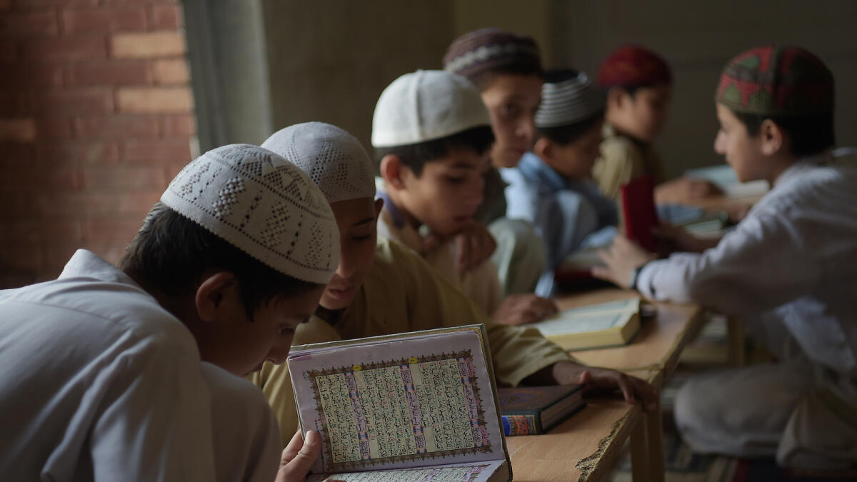 Pakistani religious students read the Quran at a mosque during the holy month of Ramadan in Islamabad on June 8, 2016.Islam's holy month of Ramadan is celebrated by Muslims worldwide marked by fasting, abstaining from foods, sex and smoking from dawn to dusk for soul cleansing and strengthening the spiritual bond between them and the Almighty. / AFP PHOTO / AAMIR QURESHI