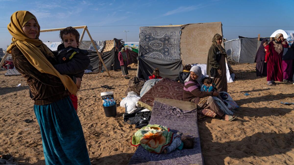 Palestinians displaced by the Israeli bombardment of the Gaza Strip gather at a tent camp, in Rafah, southern Gaza strip. (Photo: AP)
