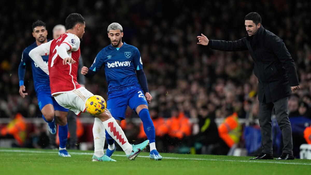 Arsenal manager Mikel Arteta gestures as West Ham's Said Benrahma (C) fights for the ball with Arsenal's William Saliba, (second left) during the English Premier League on Thursday. - AP