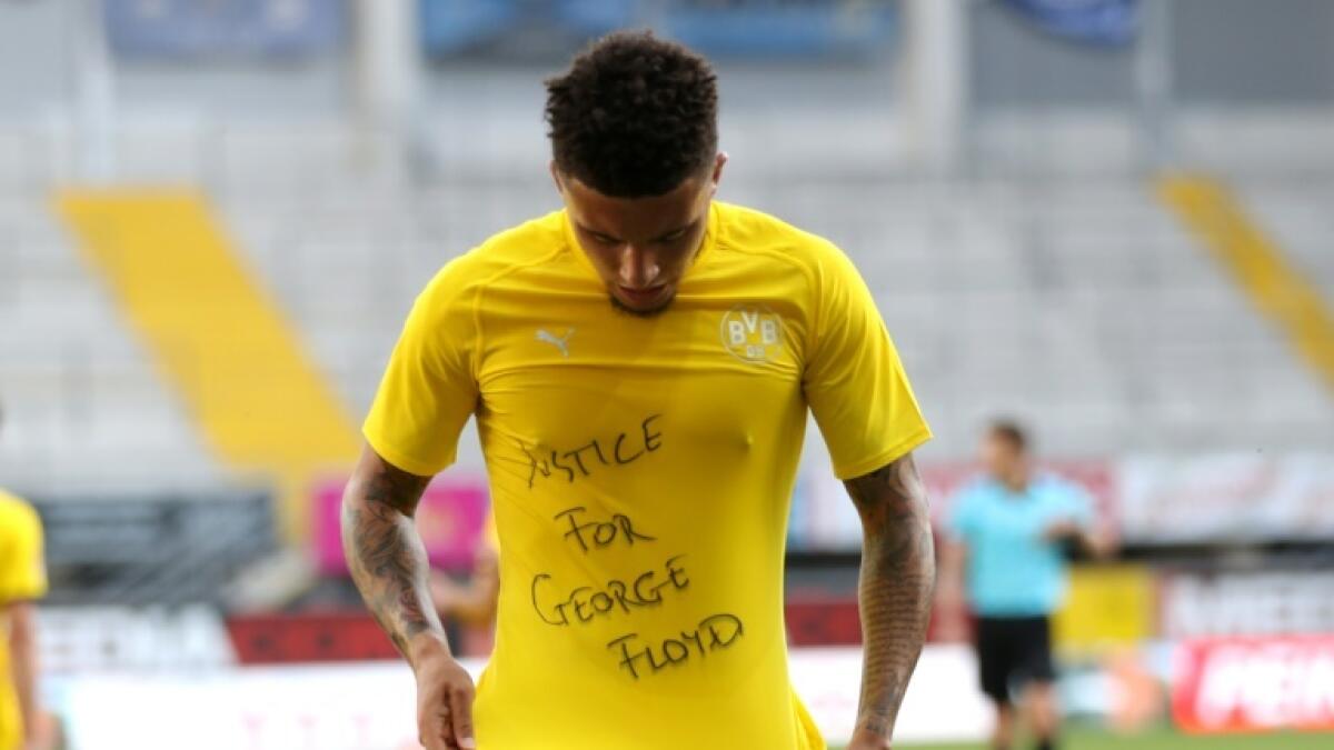 English midfielder Jadon Sancho revealed a 'Justice for George Floyd' t-shirt after scoring for Borussia Dortmund against Paderborn. - AFP file