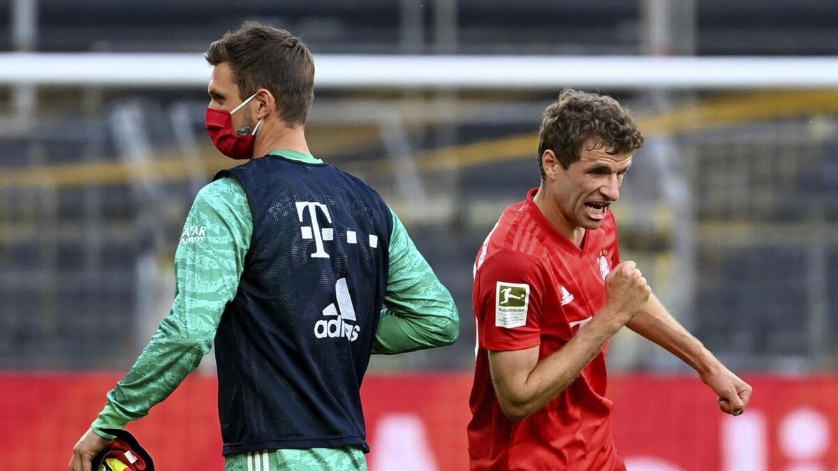 Bayern Munich's goalkeeper Sven Ulreich (left) and Thomas Mueller celebrate their team's victory. (AP)