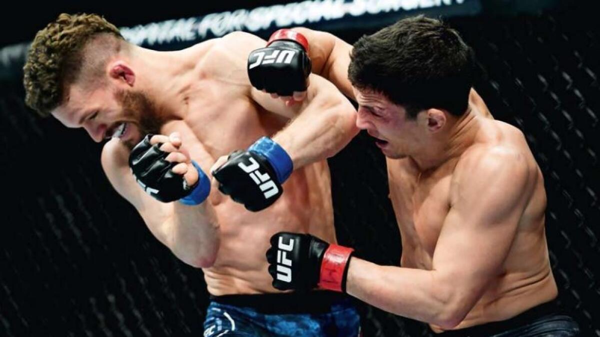 Joseph Benavidez (right) punches Dustin Ortiz during their flyweight bout at UFC Fight Night in New York. (AFP)