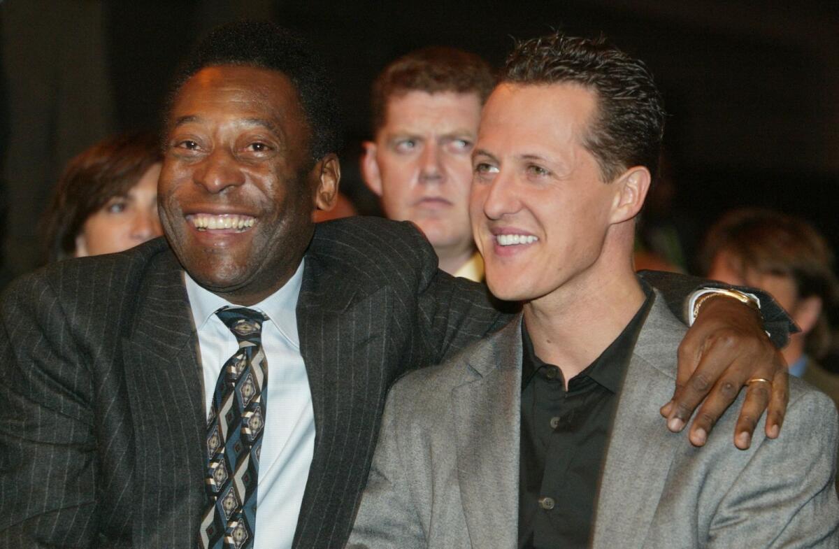 Michael Schumacher (right) with Pele. — AFP file