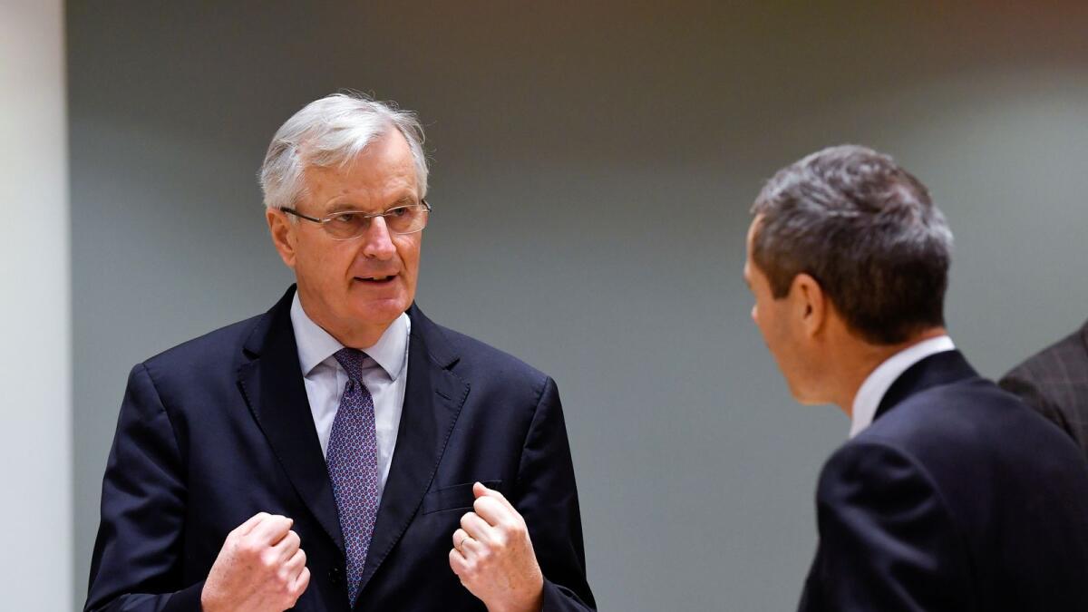 European Union's chief Brexit negotiator Michel Barnier gestures as he speaks with Ambassador Michael Clauss, Permanent Representative of Germany to the EU,  in Brussels, Belgium December 22, 2020.