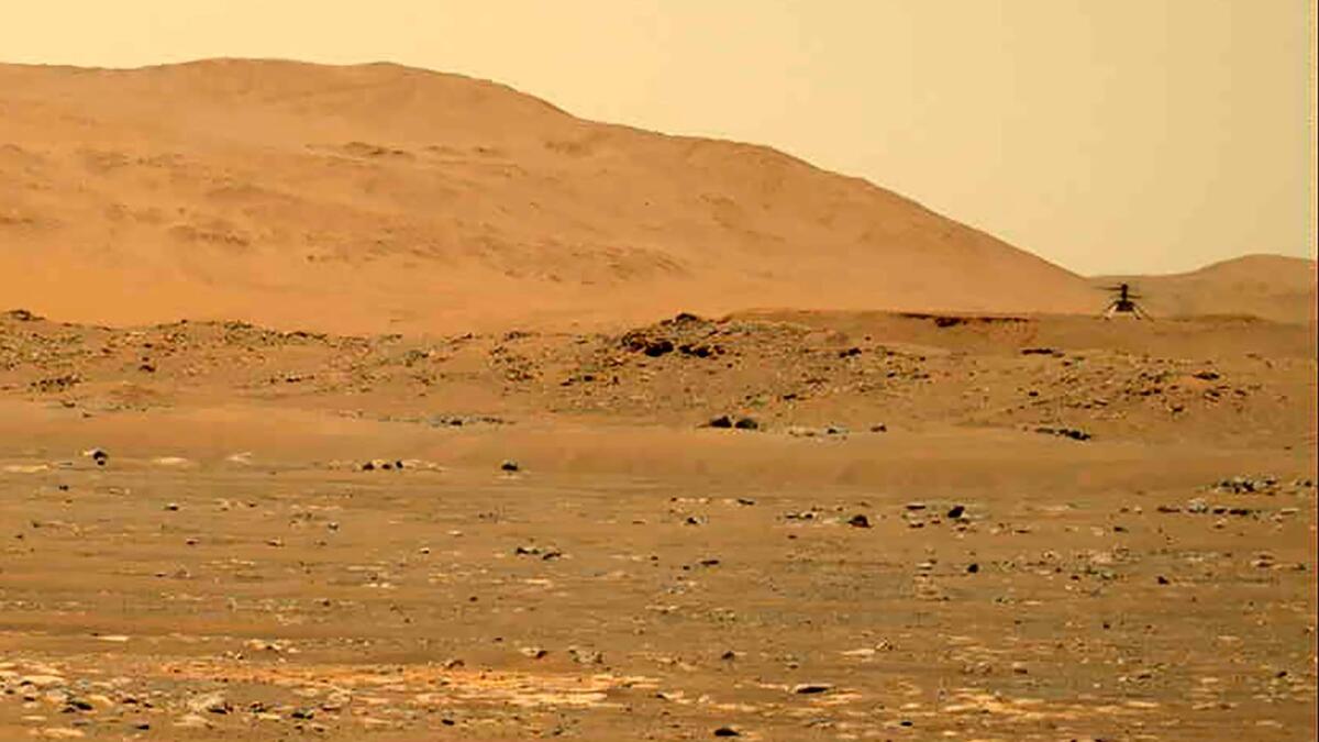 The Mars Ingenuity helicopter flies over the surface of the planet. — AP file