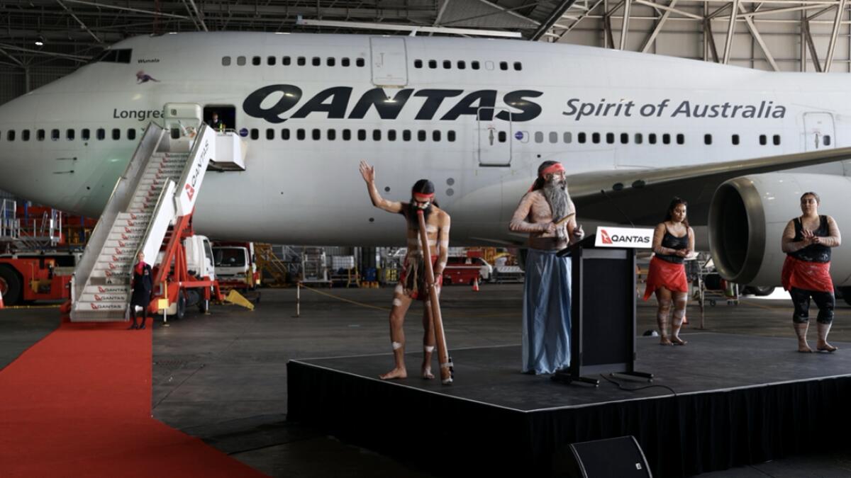 Indigenous Australians perform a ritual in front of a Qantas 747 jumbo jet, before it's last departure from the Sydney Airport in Sydney, Australia, as Qantas retires its remaining Boeing 747 planes early due to the coronavirus disease (Covid-19) pandemic. Photo: Reuters