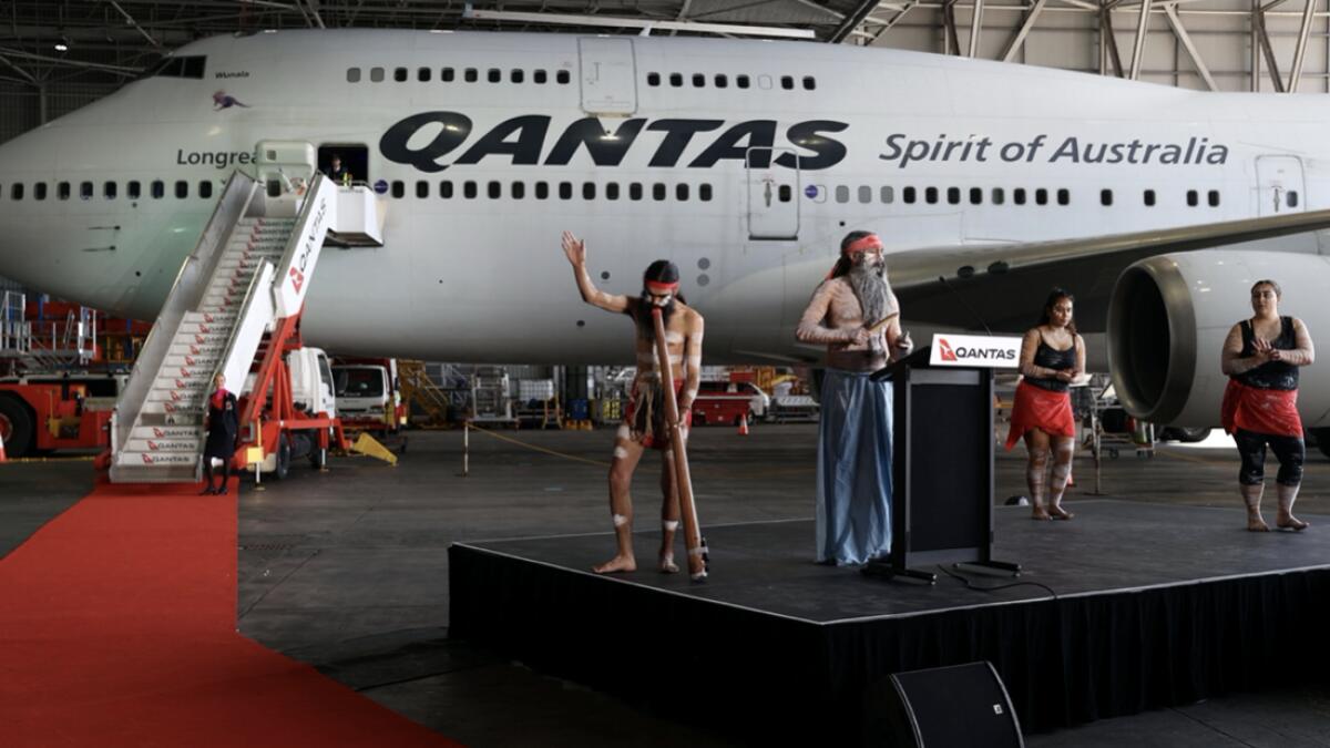 Indigenous Australians perform a ritual in front of a Qantas 747 jumbo jet, before it's last departure from the Sydney Airport in Sydney, Australia, as Qantas retires its remaining Boeing 747 planes early due to the coronavirus disease (Covid-19) pandemic. Photo: Reuters