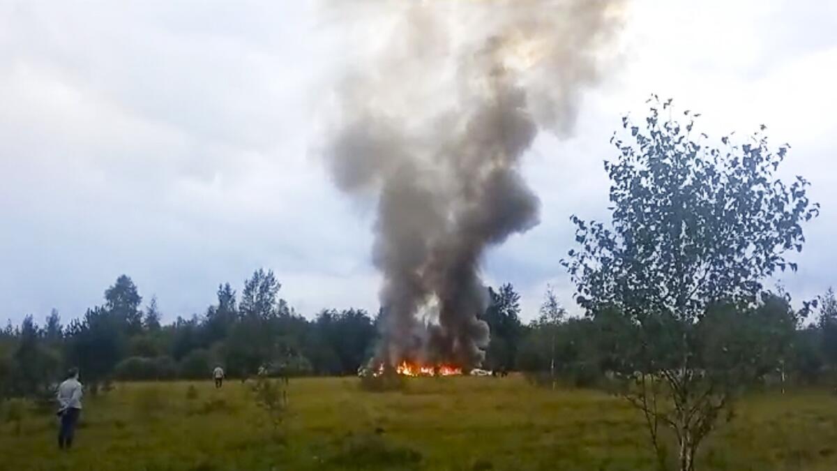 Smoke and flames rise from a crashed private jet near the village of Kuzhenkino, Tver region, Russia. — AP file