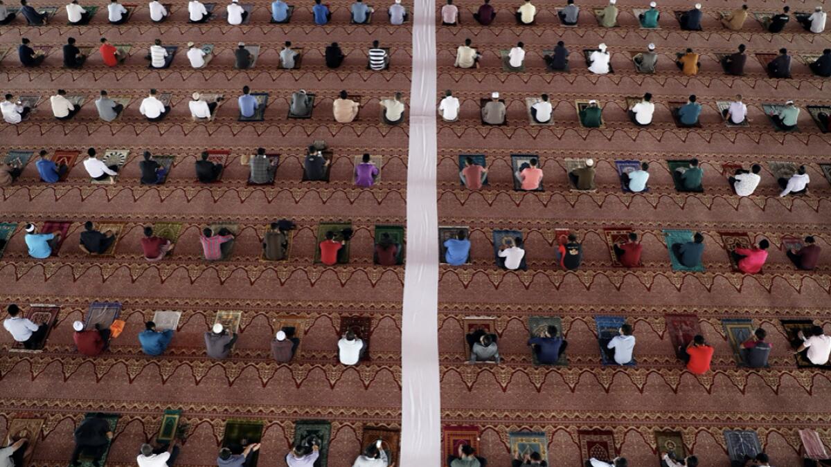Faithful following social distancing measures pray inside a mosque, amid the coronavirus disease (Covid-19) outbreak in Putrajaya, Malaysia. Photo: Reuters