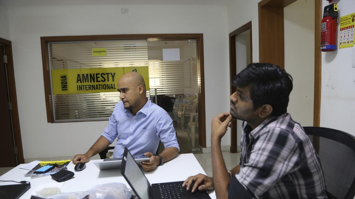 Amnesty India employees work at their headquarters in Bangalore. — File photo