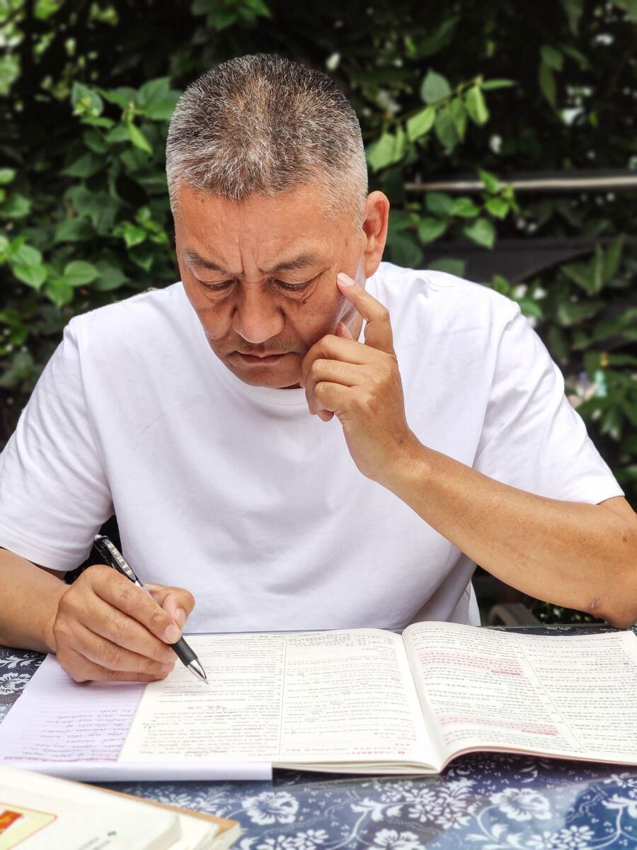 Liang Shi, a fifty-six-year-old man who sat Gaokao for the 27th time this year, going through exam papers ahead of the exam in Chengdu, in China's southwestern Sichuan province. — AFP
