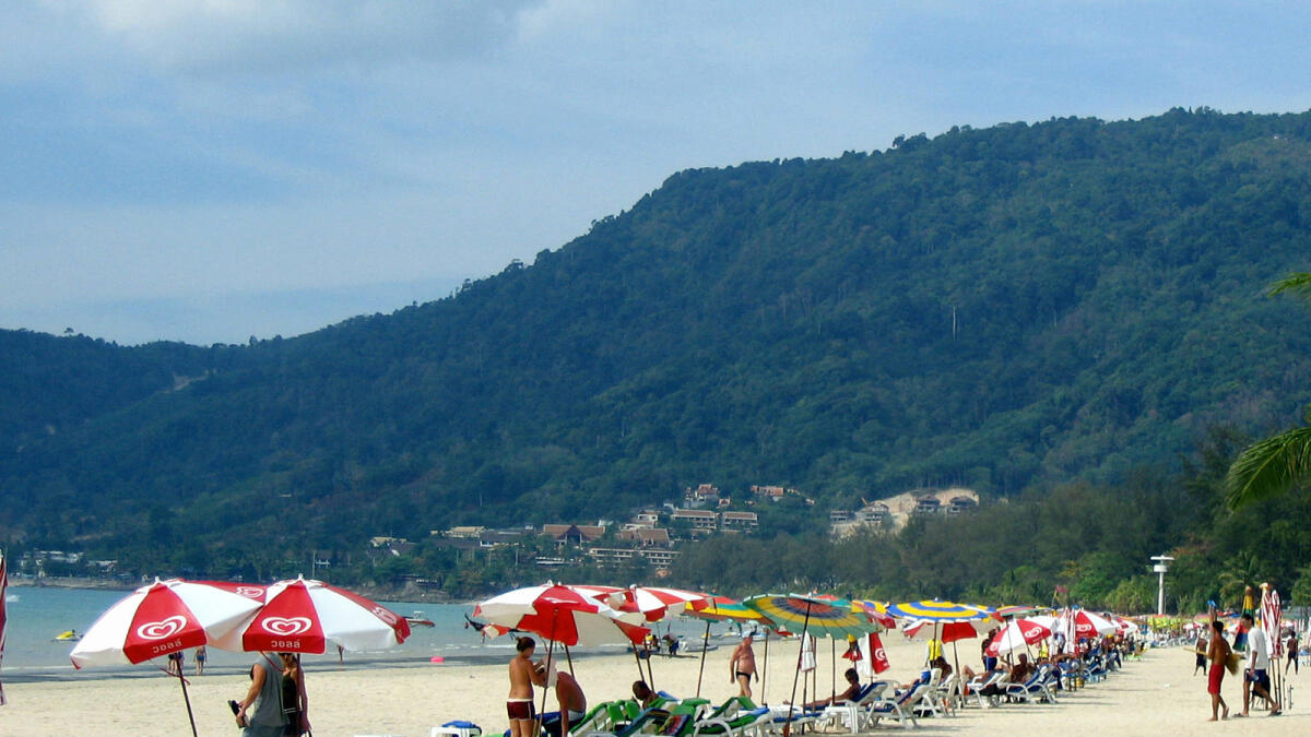 Tourists enjoy a sunny day along Patong beach in Phuket, Thailand. Online visa applications to the country have reached its quota until September 7, say officials. — AFP file photo