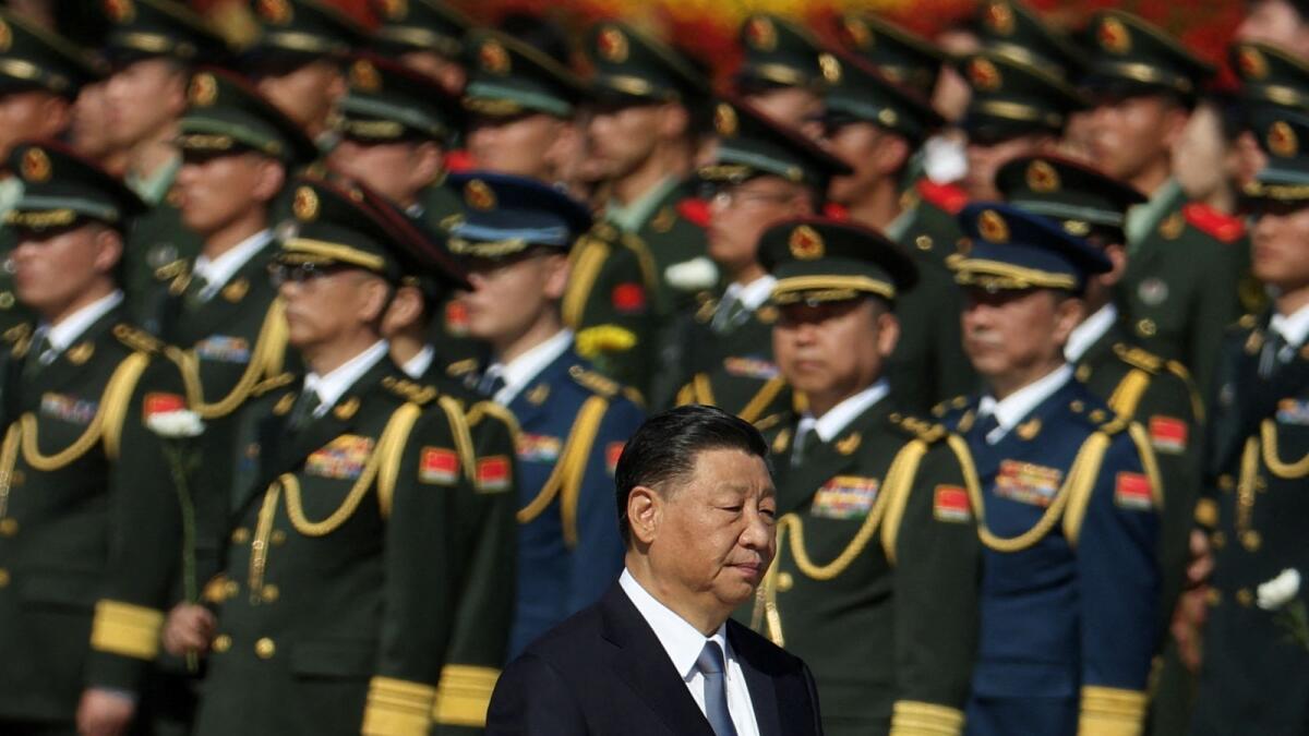 Chinese President Xi Jinping walks past members of the Chinese People's Liberation Army. — Reuters file