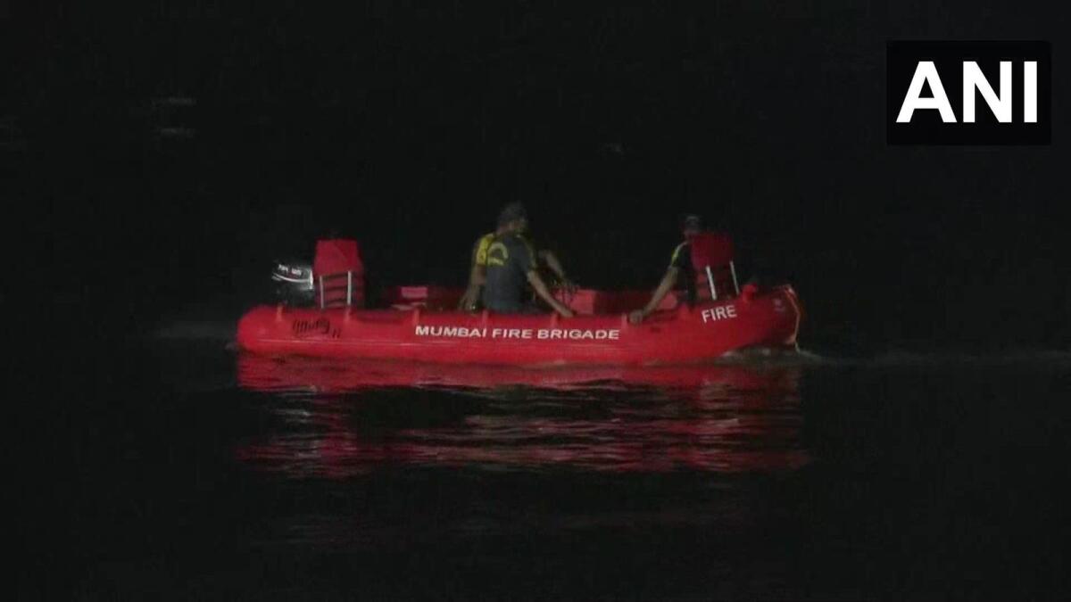 Rescue workers search for three boys in the sea at Versova in Mumbai. — ANI