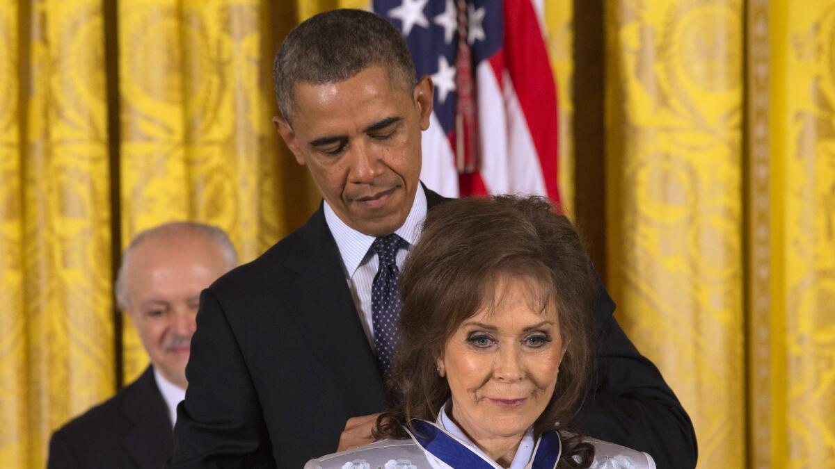 President Barack Obama awards country music legend Loretta Lynn with the Presidential Medal of Freedom, Wednesday, Nov. 20, 2013