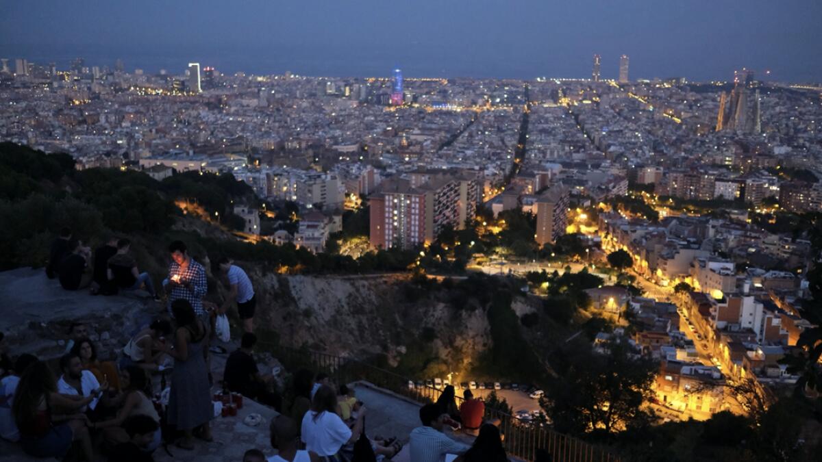 Tourists and locals gather at a lookout point, with a view of the city of Barcelona in the background, after regional authorities across Spain introduced fresh coronavirus disease (Covid-19) restrictions aimed at stamping out a surge in infections, in Barcelona, Spain. Photo: Reuters