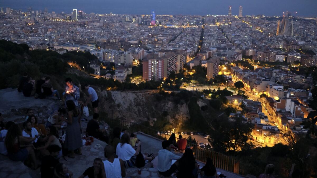 Tourists and locals gather at a lookout point, with a view of the city of Barcelona in the background, after regional authorities across Spain introduced fresh coronavirus disease (Covid-19) restrictions aimed at stamping out a surge in infections, in Barcelona, Spain. Photo: Reuters