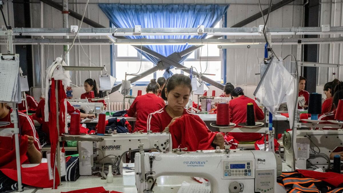Uyghur workers at a garment factory in the Xinjiang region of China on August 3, 2019. Experts have estimated that roughly one in five cotton garments sold globally contains cotton or yarn from Xinjiang. (Gilles Sabrié/The New York Times)