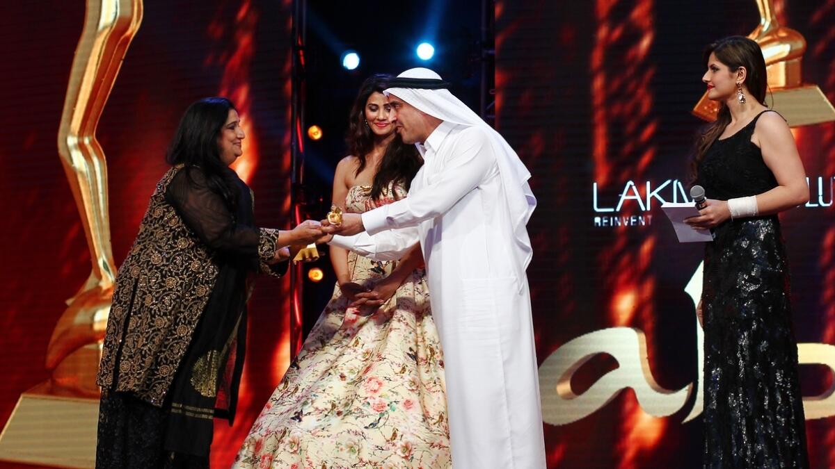Mr Suhail Abdul Latif Galadari of Galadari Brothers LLC gives the award for Best Actress in a Supporting Role to Seema Pahwa, in Dubai, on May 29, 2015.