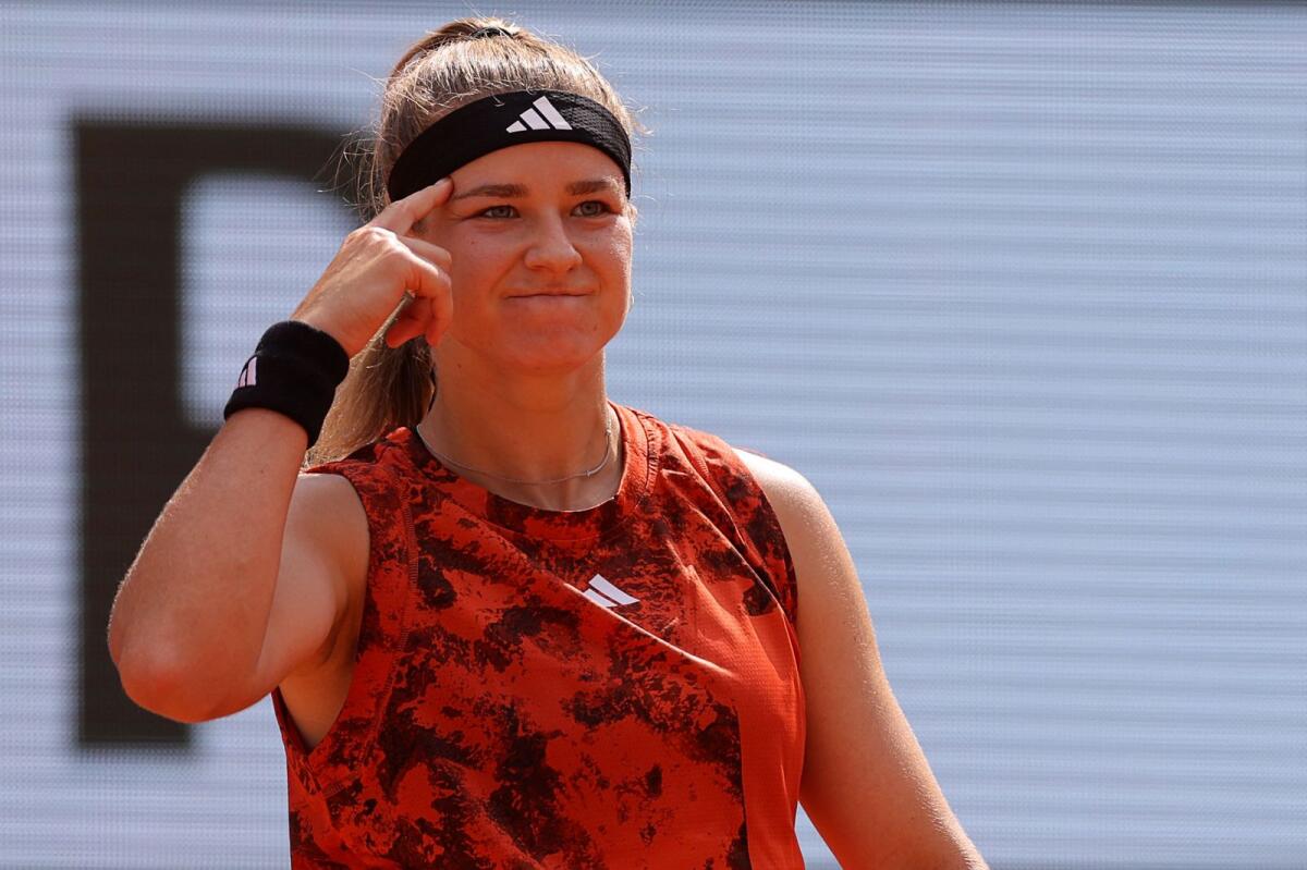 Karolina Muchova gestures as she plays against Iga Swiatek. — AFP
