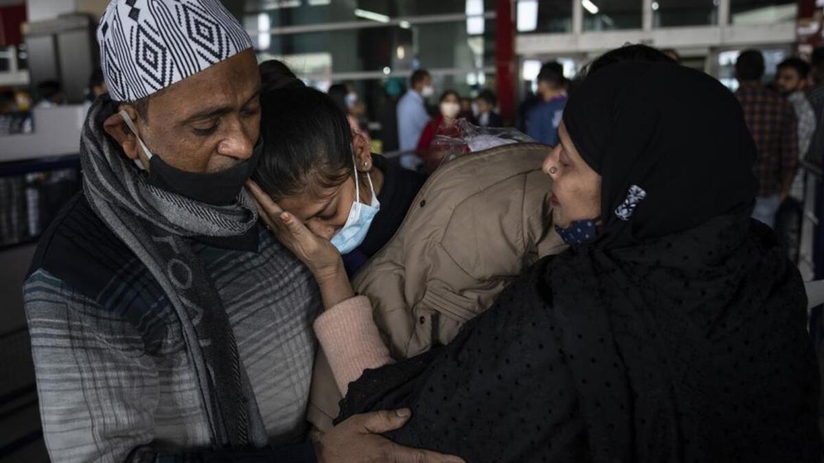 Parents hug Iqra Praveen, centre, an Indian student studying in Ukraine who fled the conflict, after she arrived at Indira Gandhi International Airport in New Delhi, India, Wednesday, March 2, 2022. —AP