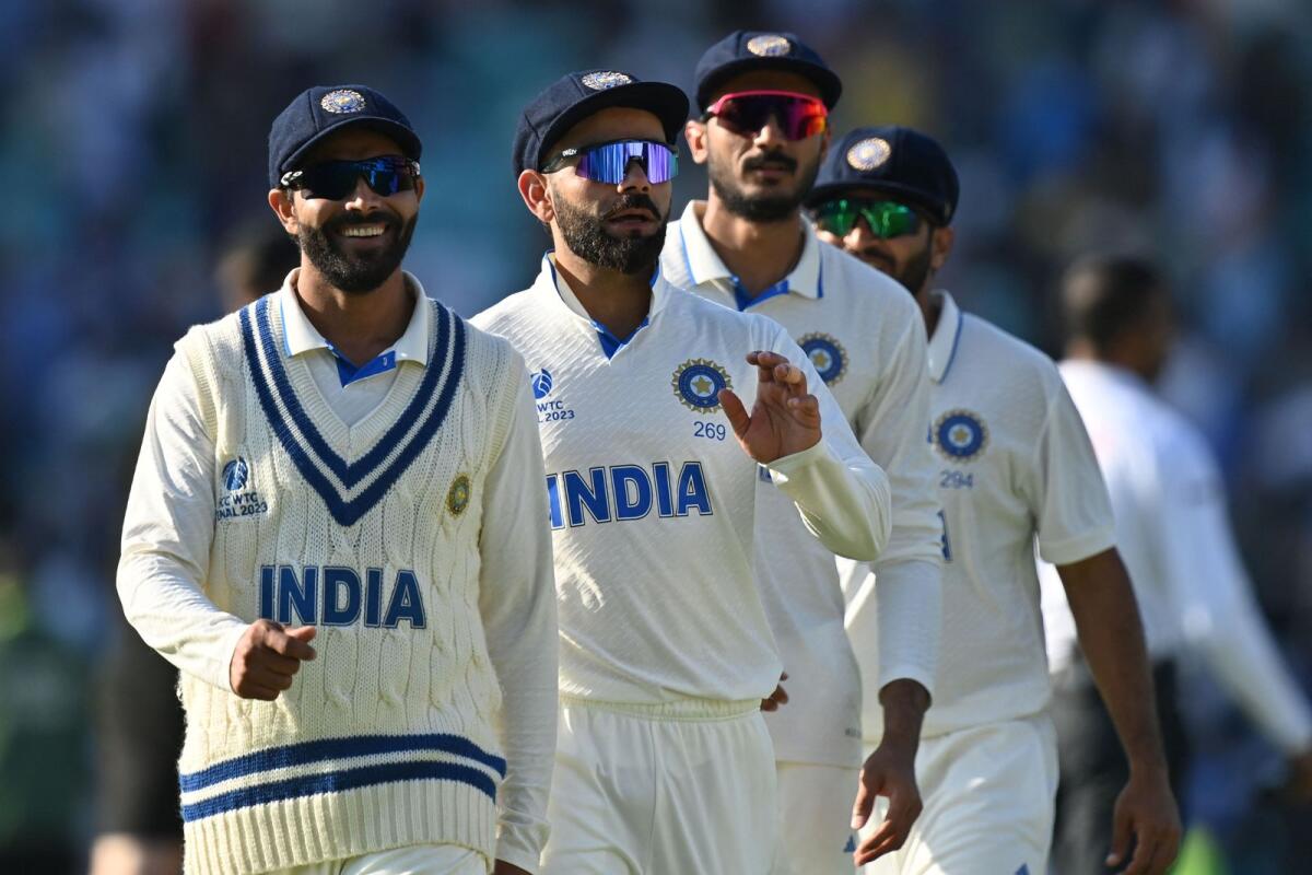 India's Virat Kohli (centre) leads players off the pitch at the end of play on day three. — AFP