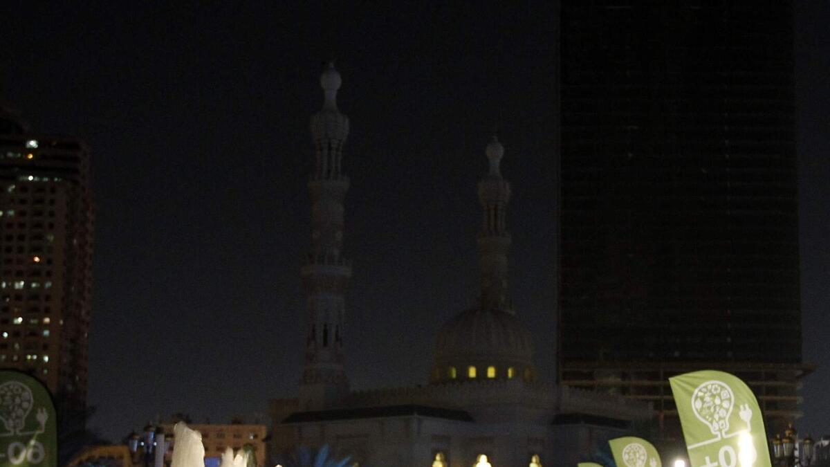 IN SHARJAH... Al Majaz Waterfront before and during Earth Hour. — Photos by M. Sajjad