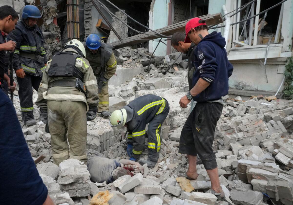 Rescue workers clear debris of a building after a Russian air raid in Lysychansk, Luhansk region. –AP