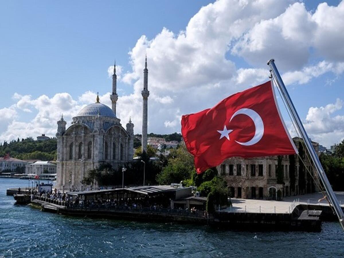 A Turkish flag is pictured on a boat with the Ortakoy Mosque in the background in Istanbul. the UAE is keen to explore cooperation with Türkiye in the realms of education, tourism, and culture.