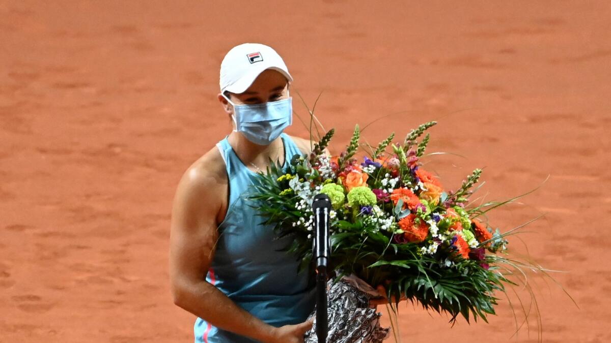 Ashleigh Barty of Australia holds a flower bouquet she received as a birthday present after defeating Elina Svitolina of Ukraine in the semifinal.— AP