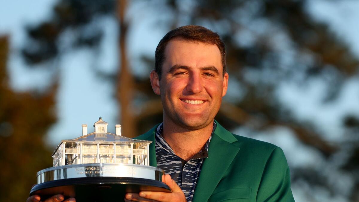 Scottie Scheffler poses with the Masters trophy during the Green Jacket Ceremony.   (AFP)