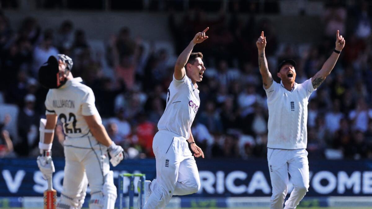 England's Matthew Potts (centre) celebrates alongside teammate Ben Stokes after taking the wicket of New Zealand's Kane Williamson (left). — Reuters