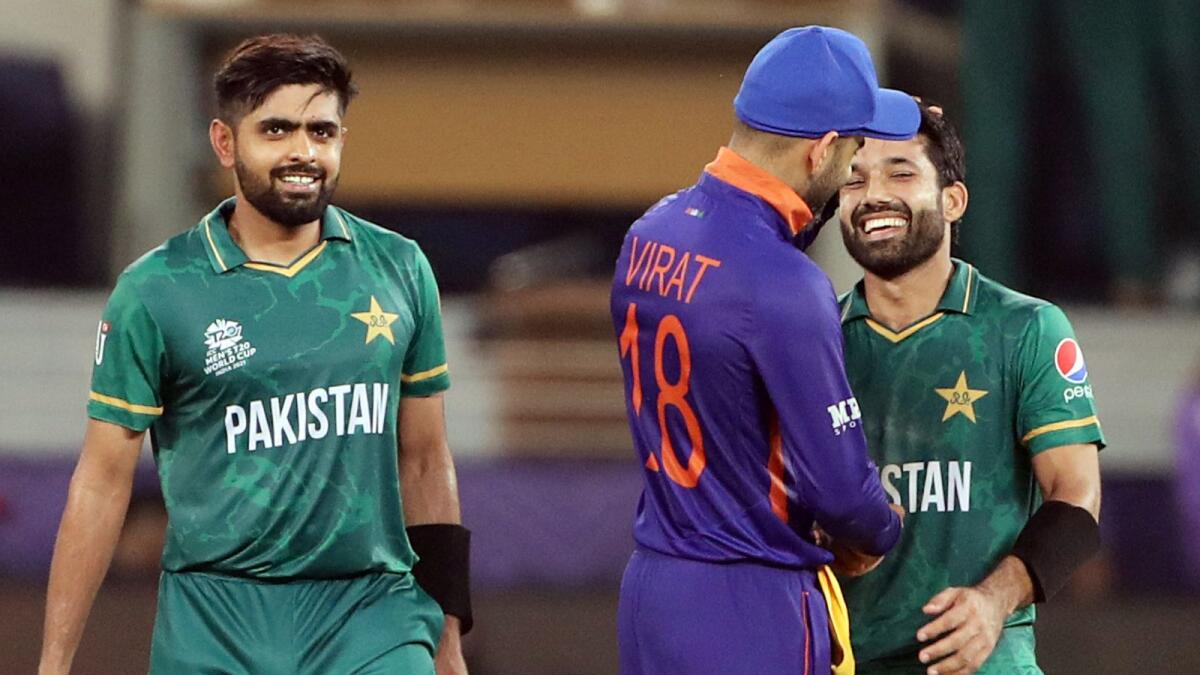 India's captain Virat Kohli congratulates Pakistan's Mohammad Rizwan and Babar Azam following their victory. (ANI)
