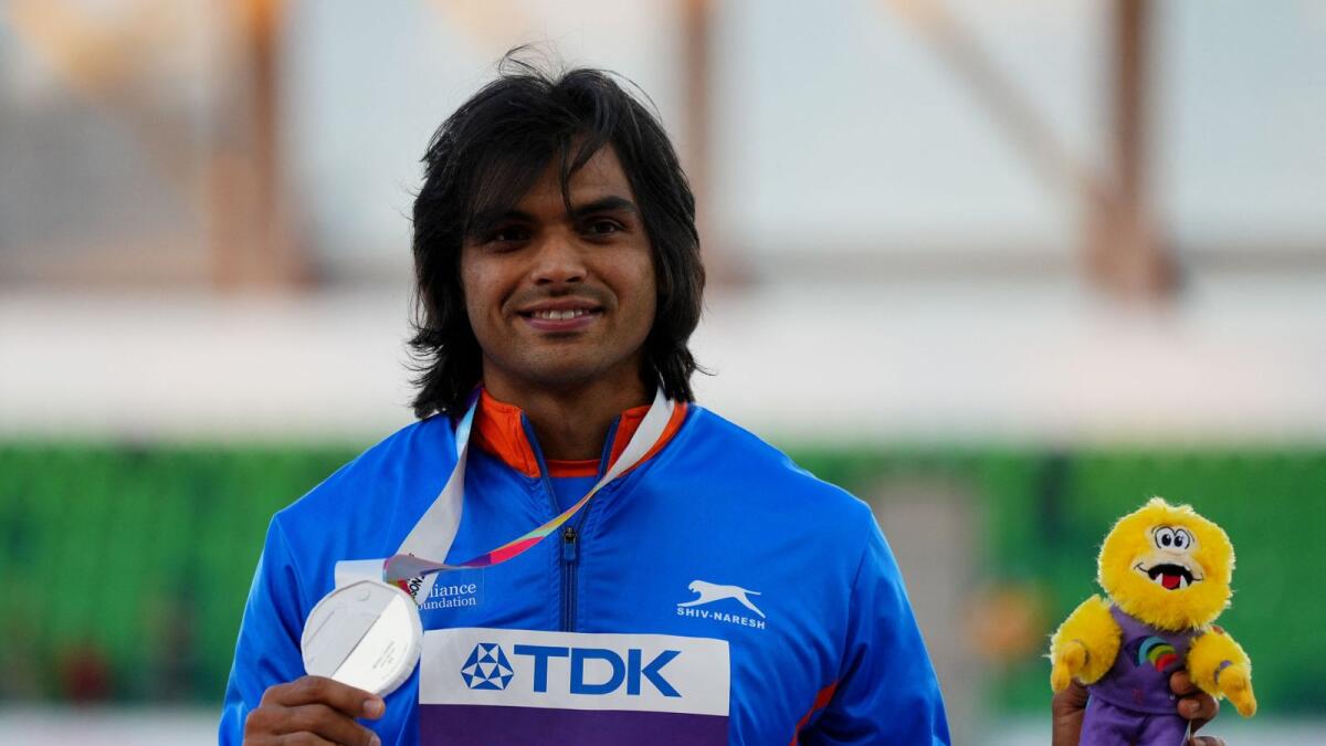 Neeraj Chopra celebrates on the podium during the medal ceremony. — Reuters
