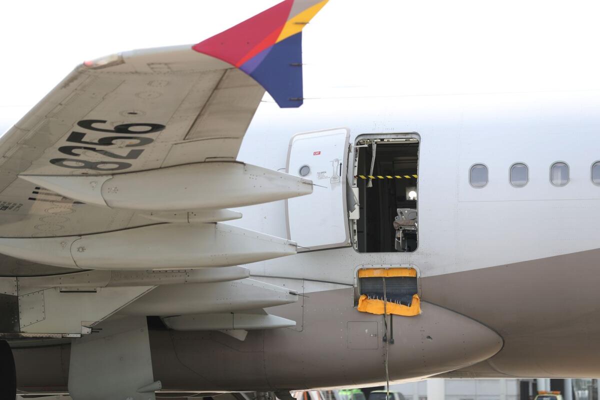 An Asiana Airlines plane is parked as one of the plane's doors suddenly opened at Daegu International Airport in Daegu, South Korea, on Friday. — AP