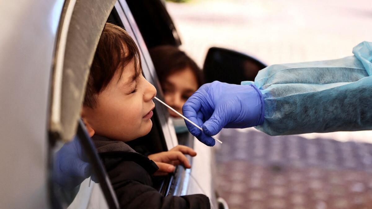 A boy is tested for the coronavirus disease at a drive-through site in Israel. (Reuters)