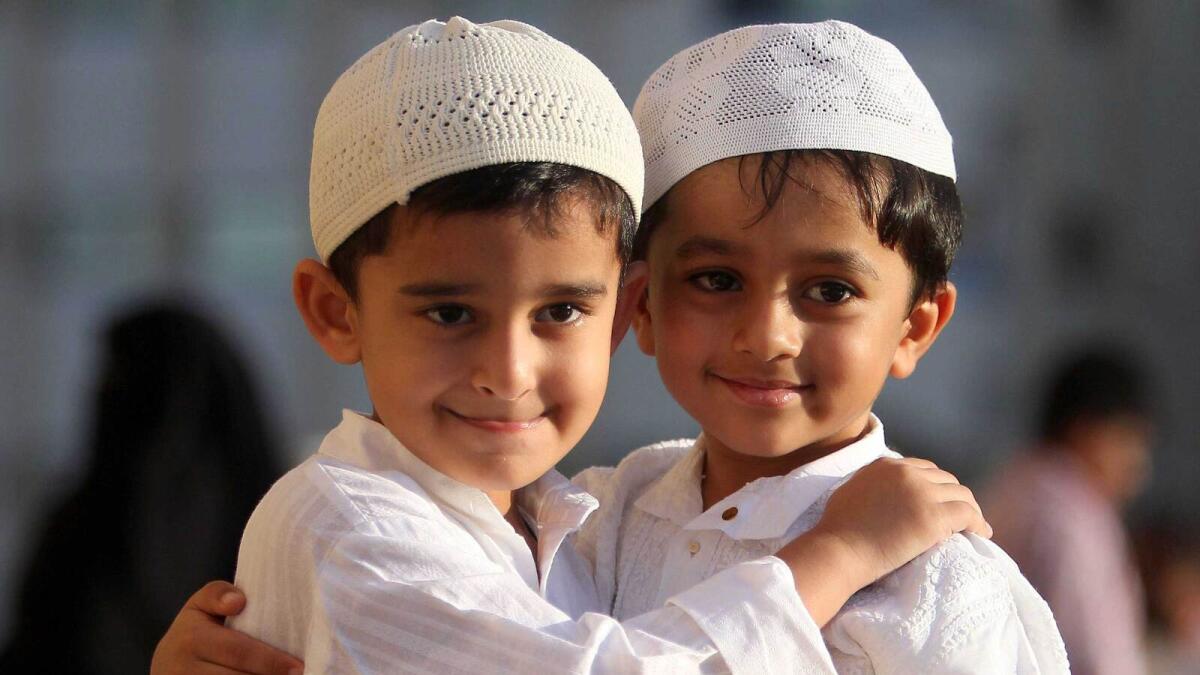 Kids greet with each other after offering Eid Al Adha prayer at the King Faisal Masque in Sharjah.-Photo by M.Sajjad/Khaleej Times