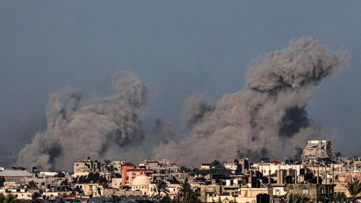 A picture taken from Rafah shows smoke billowing over the southern Gaza Strip during Israeli bombardment. — AFP