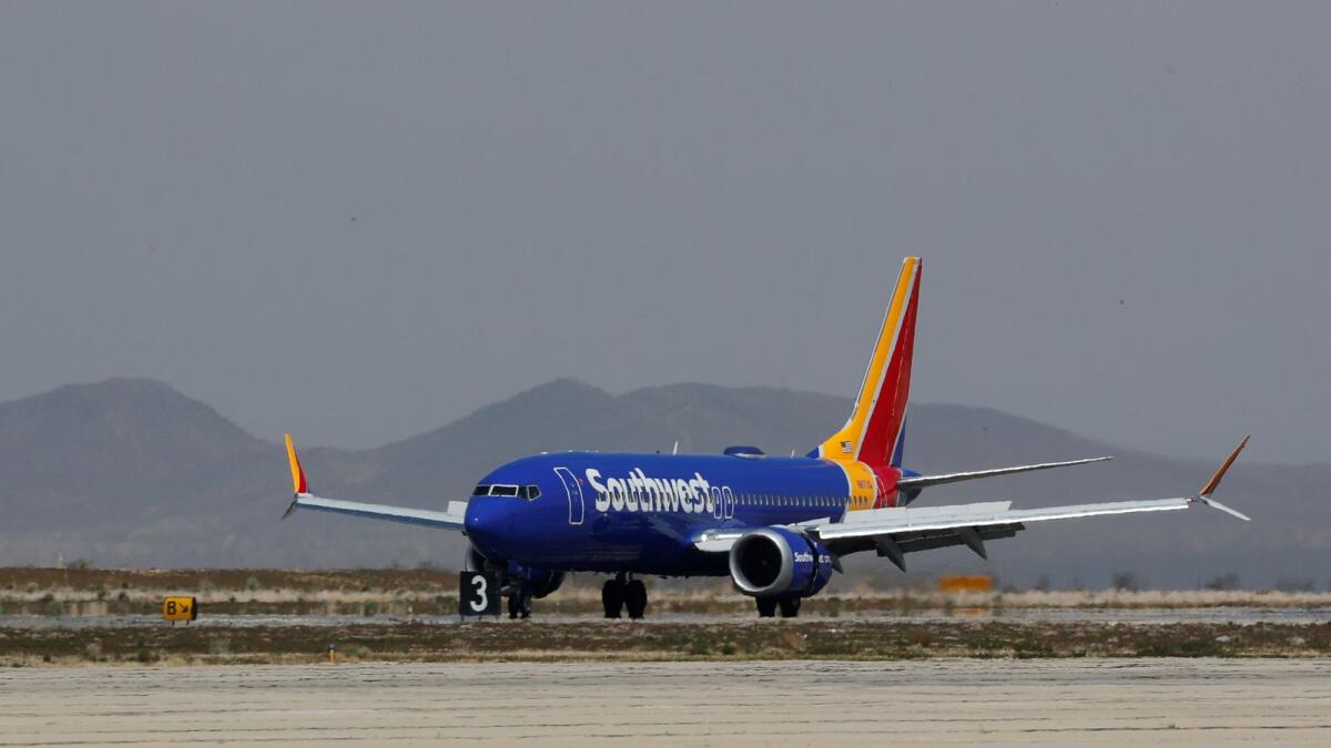 FILE PHOTO: A Southwest Airline Boeing 737 MAX 8 aircraft lands at Victorville Airport in Victorville, California, U.S., March 26, 2019.  REUTERS/Mike Blake/File Photo