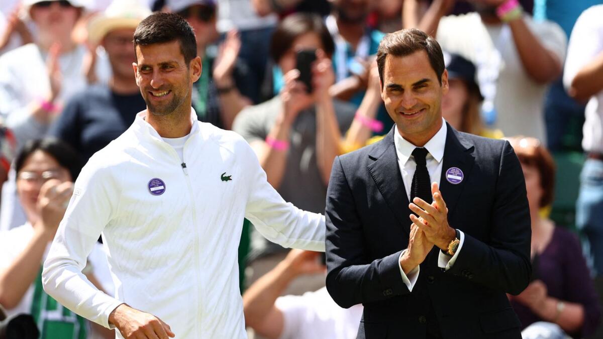 Roger Federer and Novak Djokovic take part in the Centre Court Centenary Ceremony on Sunday. (AFP)