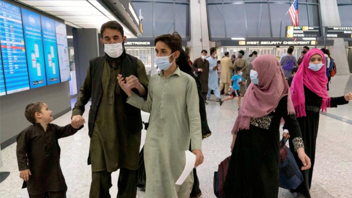 Families evacuated from Kabul arrive at Washington Dulles International Airport. — AP