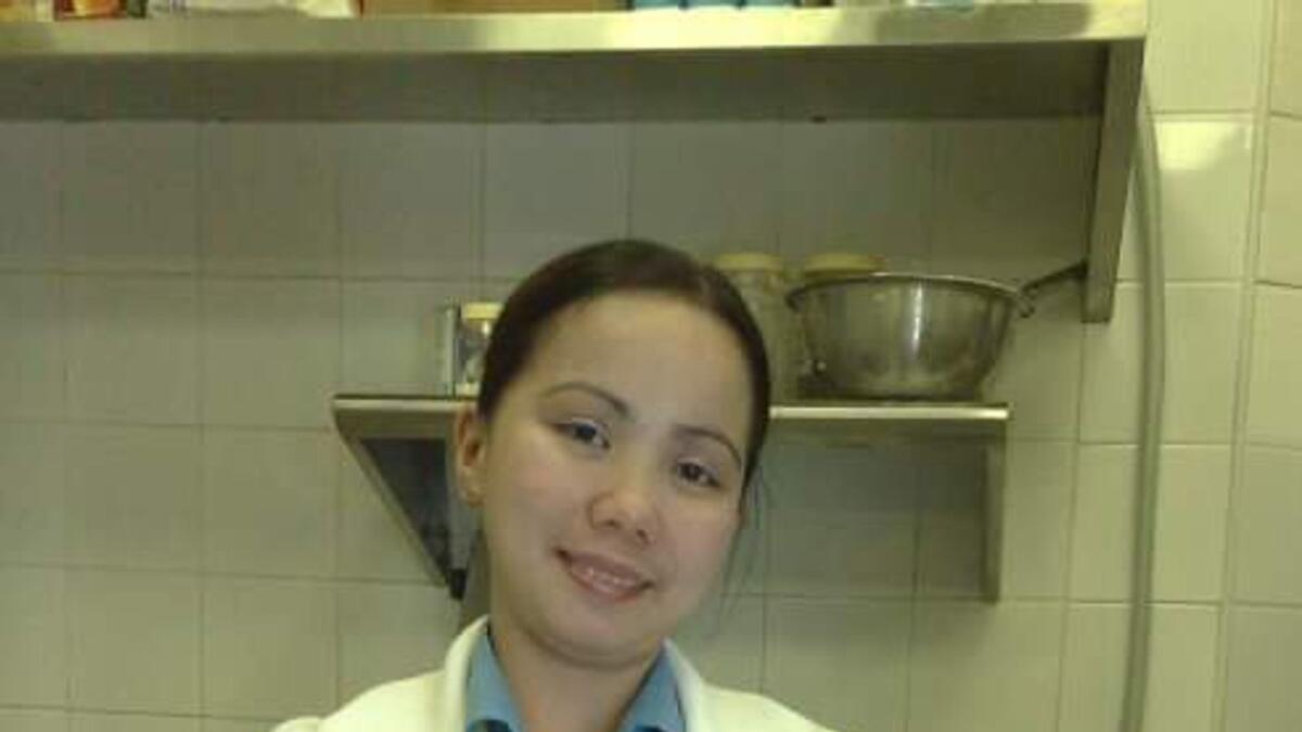 Aisha during her job as a waitress at a seafood restaurant in Abu Dhabi.